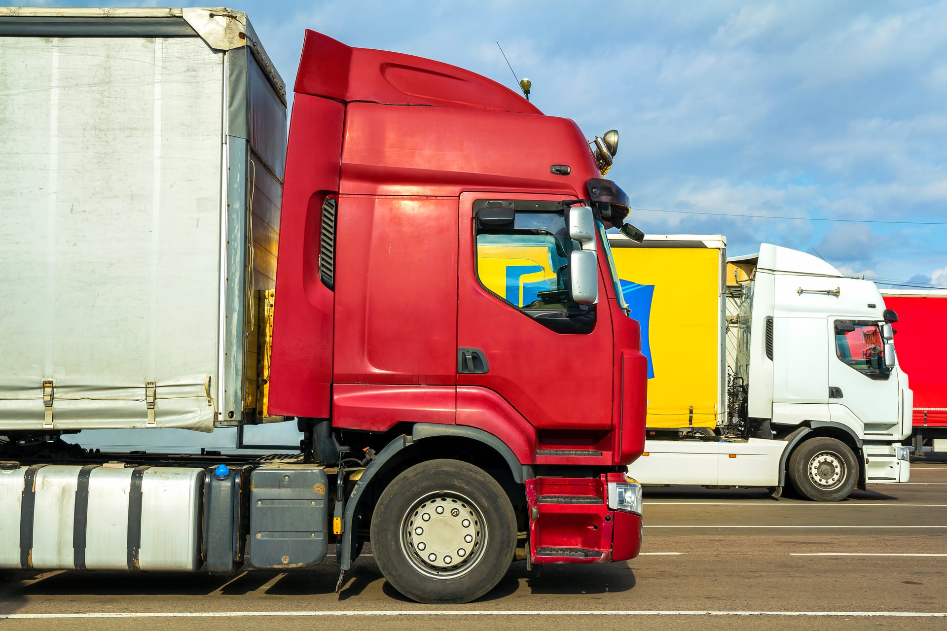 Modern semi trucks lined up at fleet yard